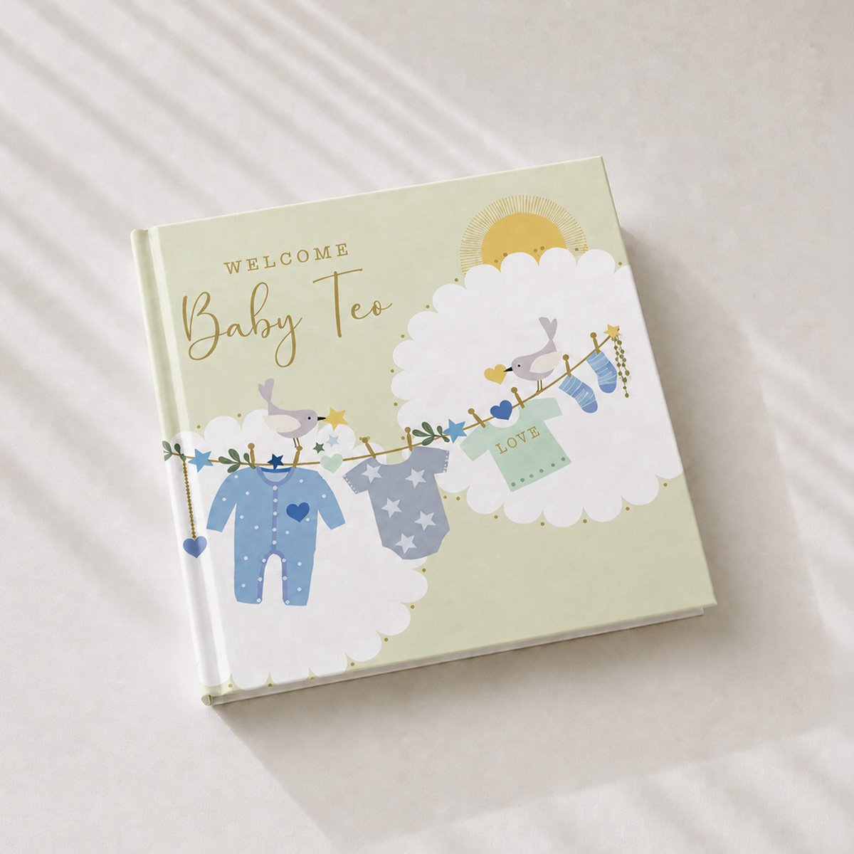 Personalised baby memory book with a baby clothes illustration